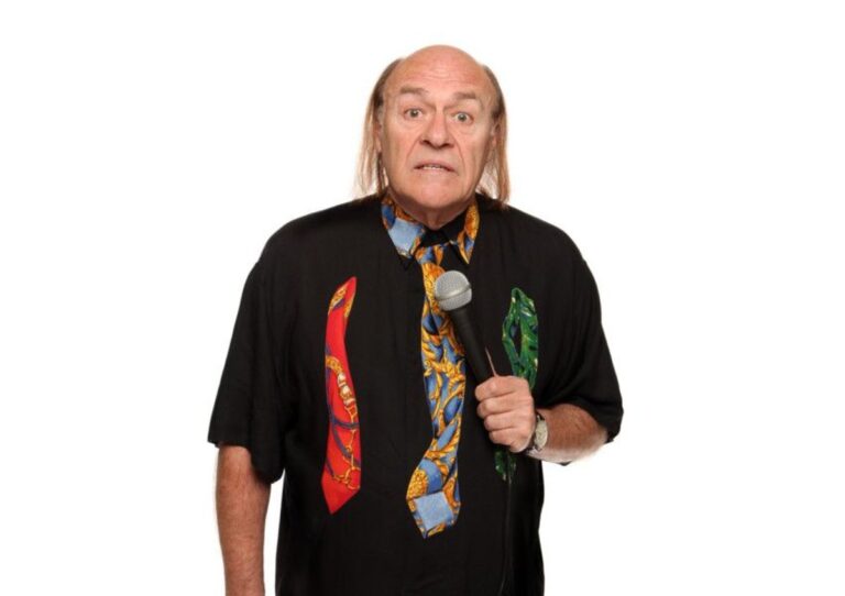 mick miller comedian holding a microphone
