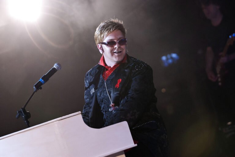 Picture of elton john tribute singing and posing on stage