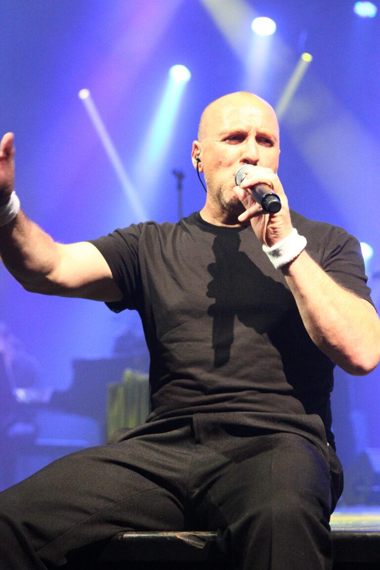 picture of rob l Phil Collins tribute singing on front of the stage