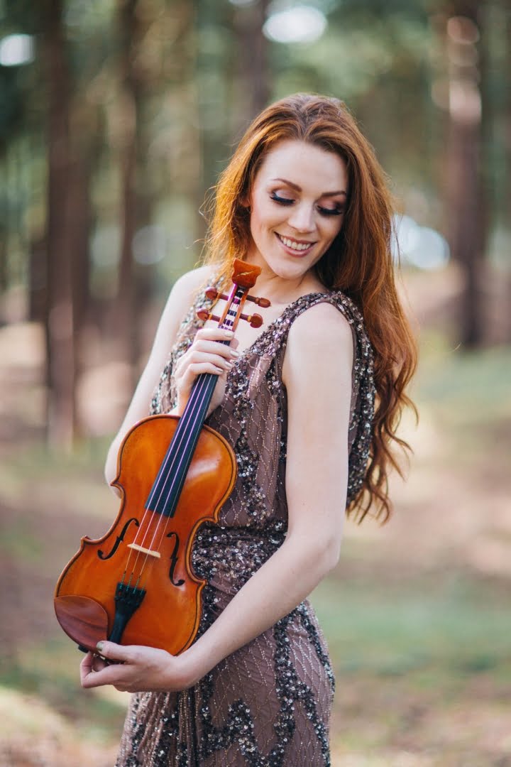 Violinist in forest playing violin