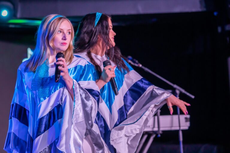 Picture of Abba tribute band on stage with costumes