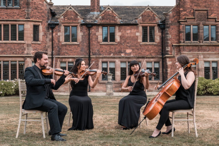 The Wedding String Quartet playing in front of wedding venue