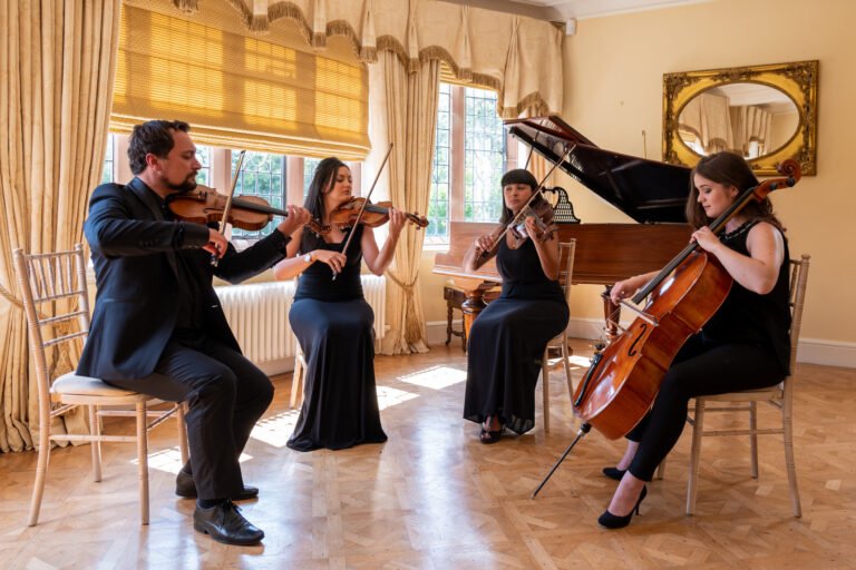 The Wedding String Quartet Playing instruments in wedding venue