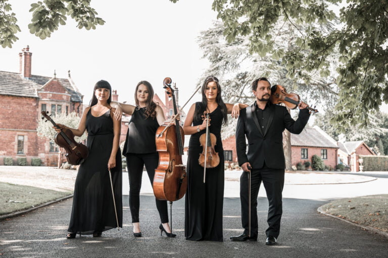 The Wedding String Quartet posing for photograph with instruments