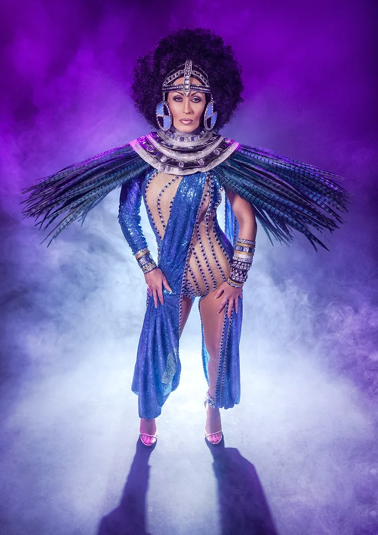 Simply Cher in costume with feathers