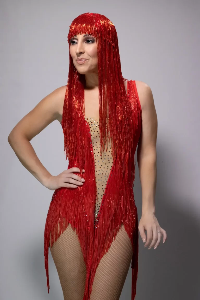 The Cher Show posing in red dress