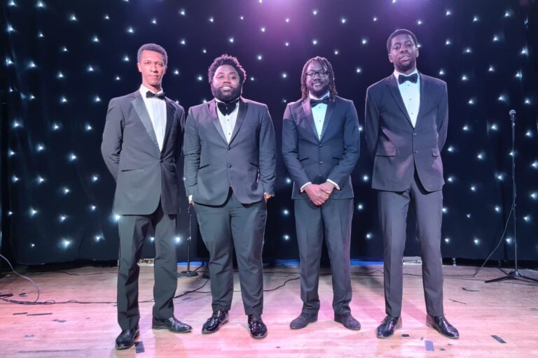 The Sensations Band in front of star backdrop