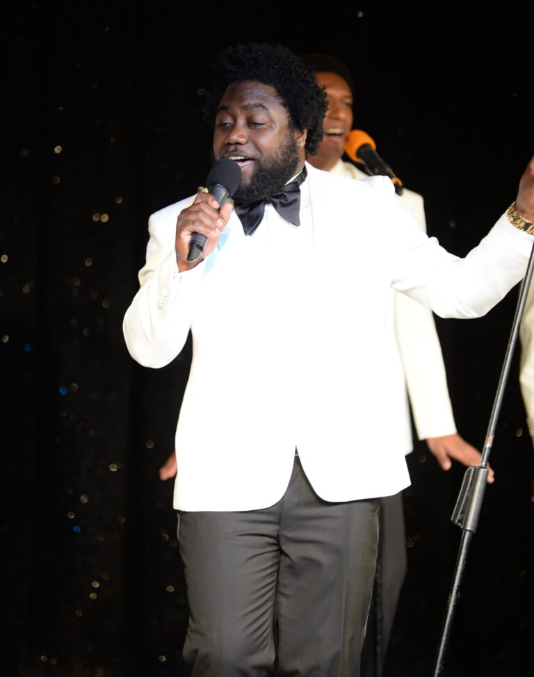 Cris Q singer in white jacket