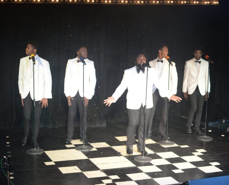 The Sensations Band ion white jackets on stage with the soul and motown show