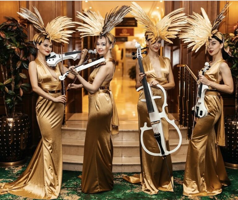 Euphoric Strings in gold dress performing at a hotel
