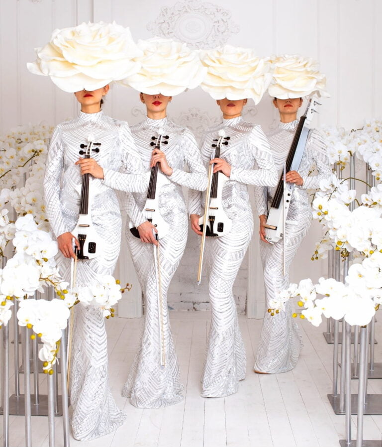 picture of Euphoric Strings in white dress and flower hat