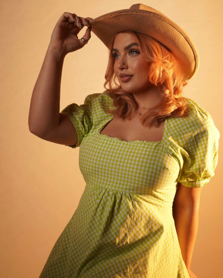 yazzmin female singer dressed in green dress and hat