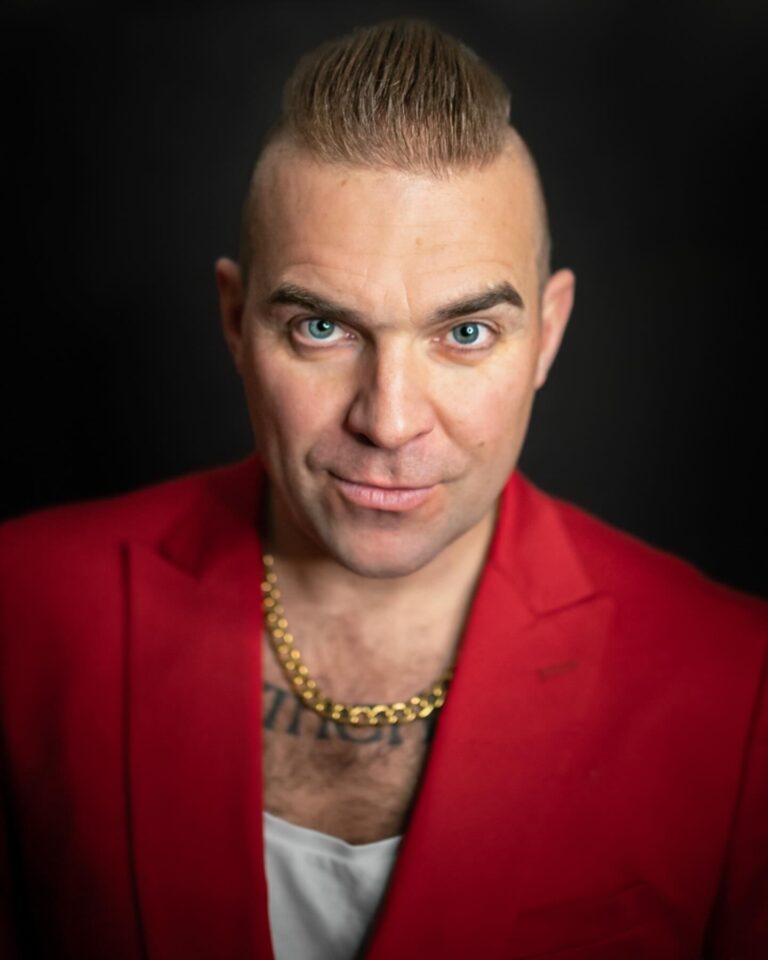robbie Williams tribute act in red suit