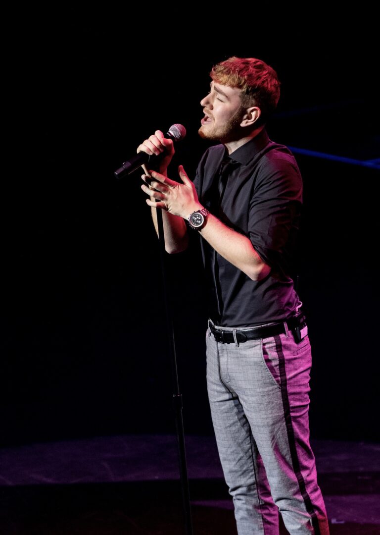 Harry L Singer on stage singing