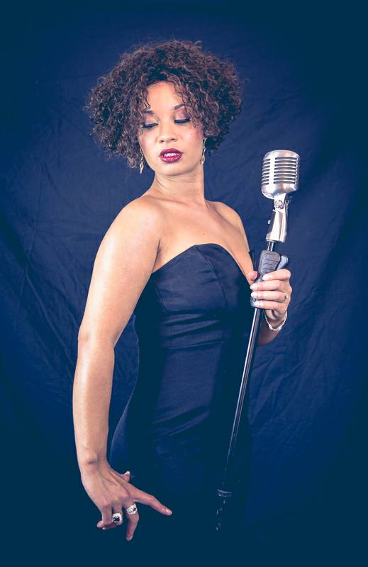 Simply Whitney - A Tribute To Whitney Houston Holding microphone