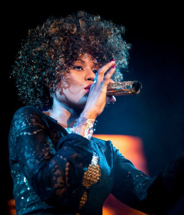 Whitney Houston Tribute holding microphone