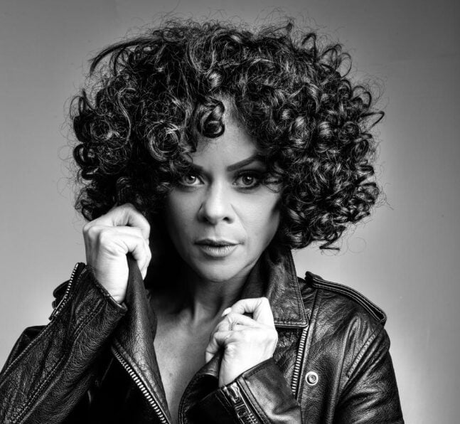 Whitney Live The Tribute headshot in black leather jacket